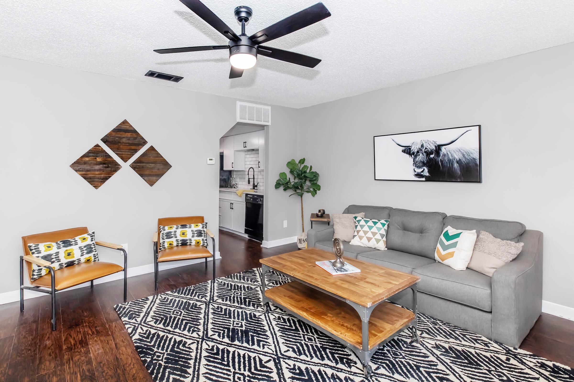 a living room filled with furniture and a flat screen tv