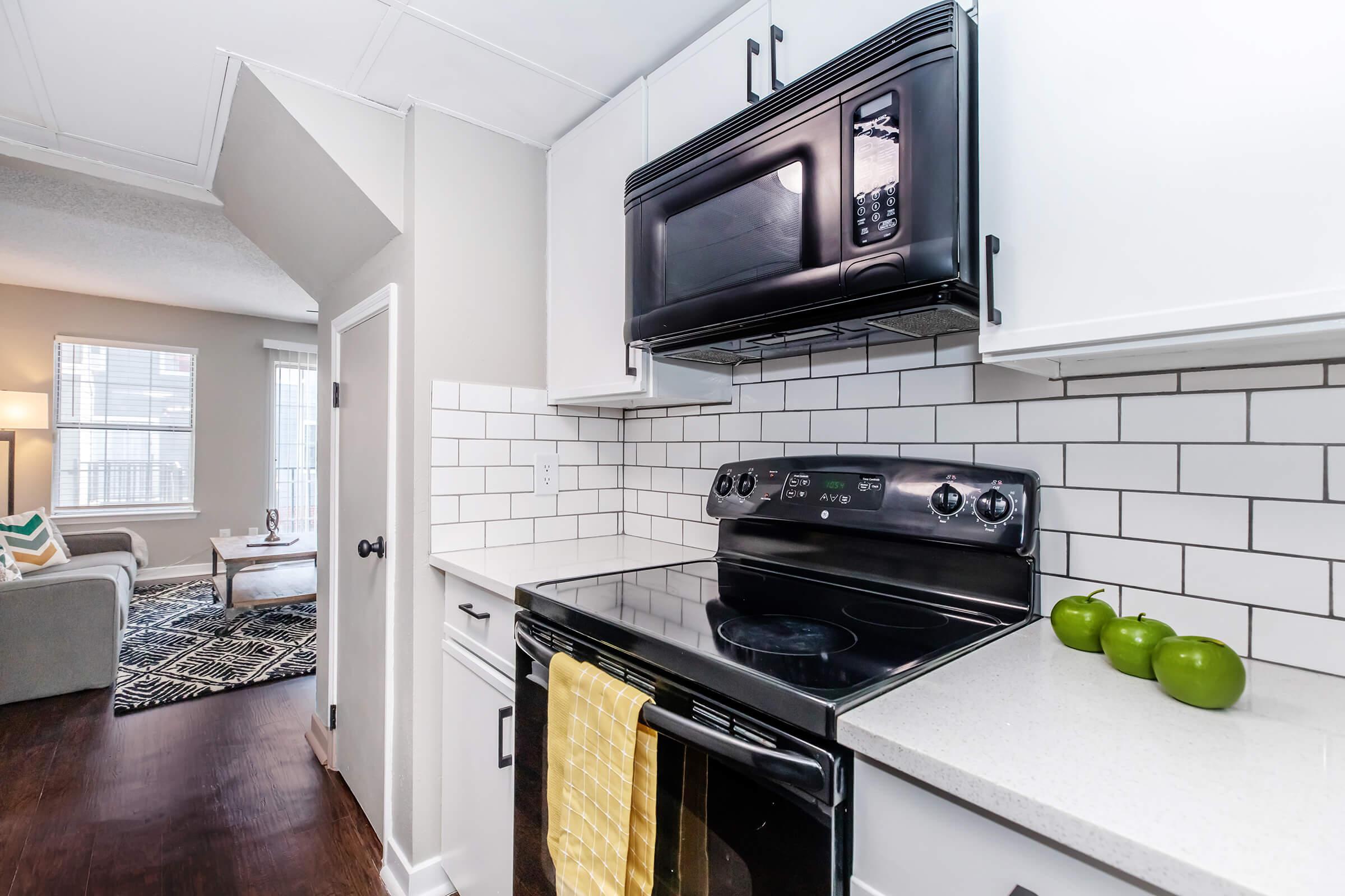 a stove top oven sitting inside of a kitchen