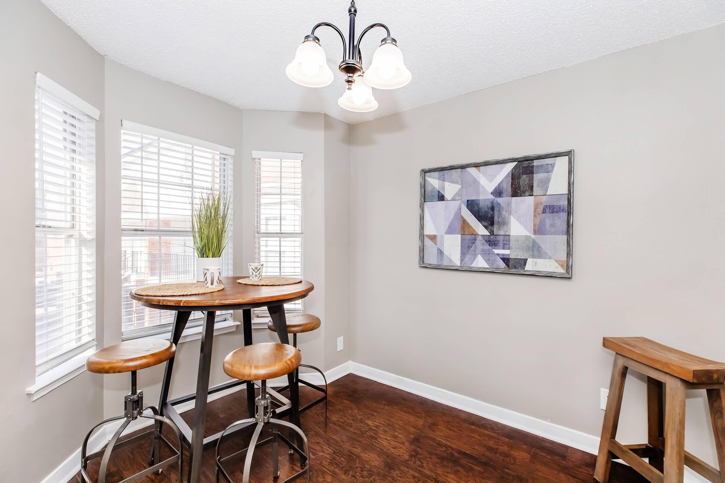 a dining room table in front of a window