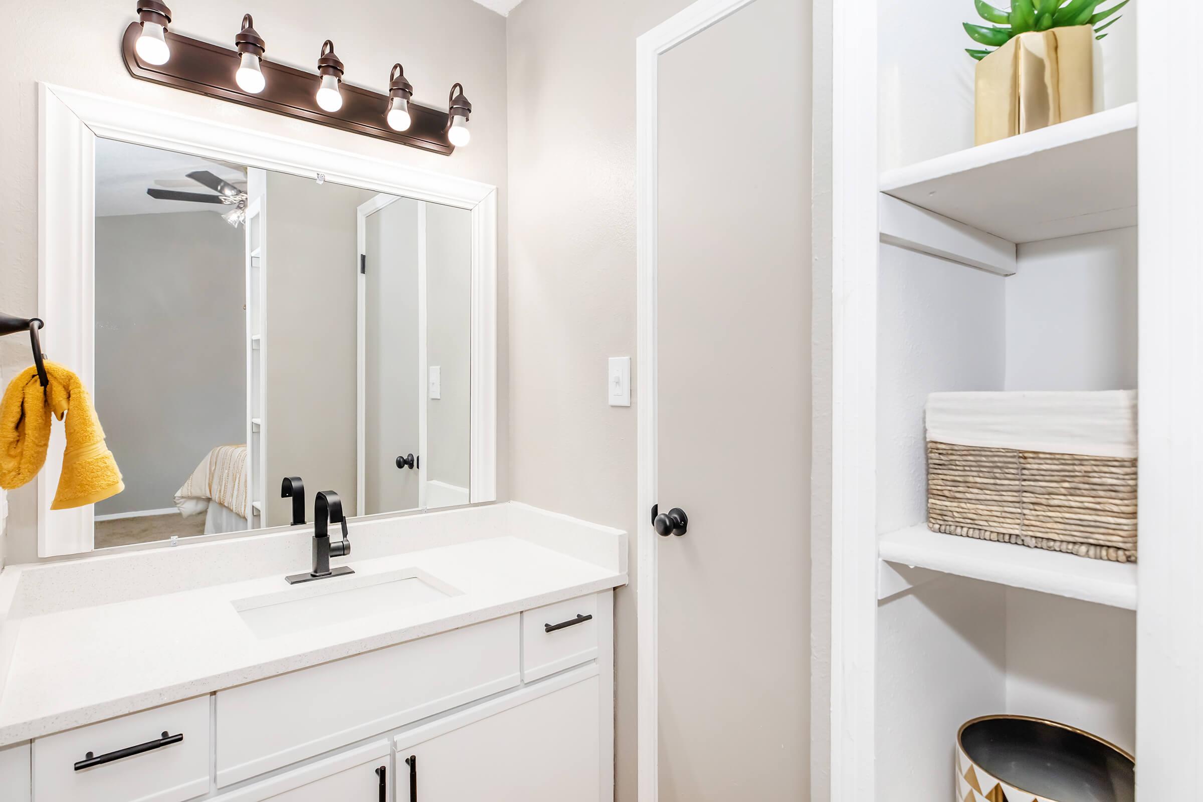 a kitchen with a sink and a mirror