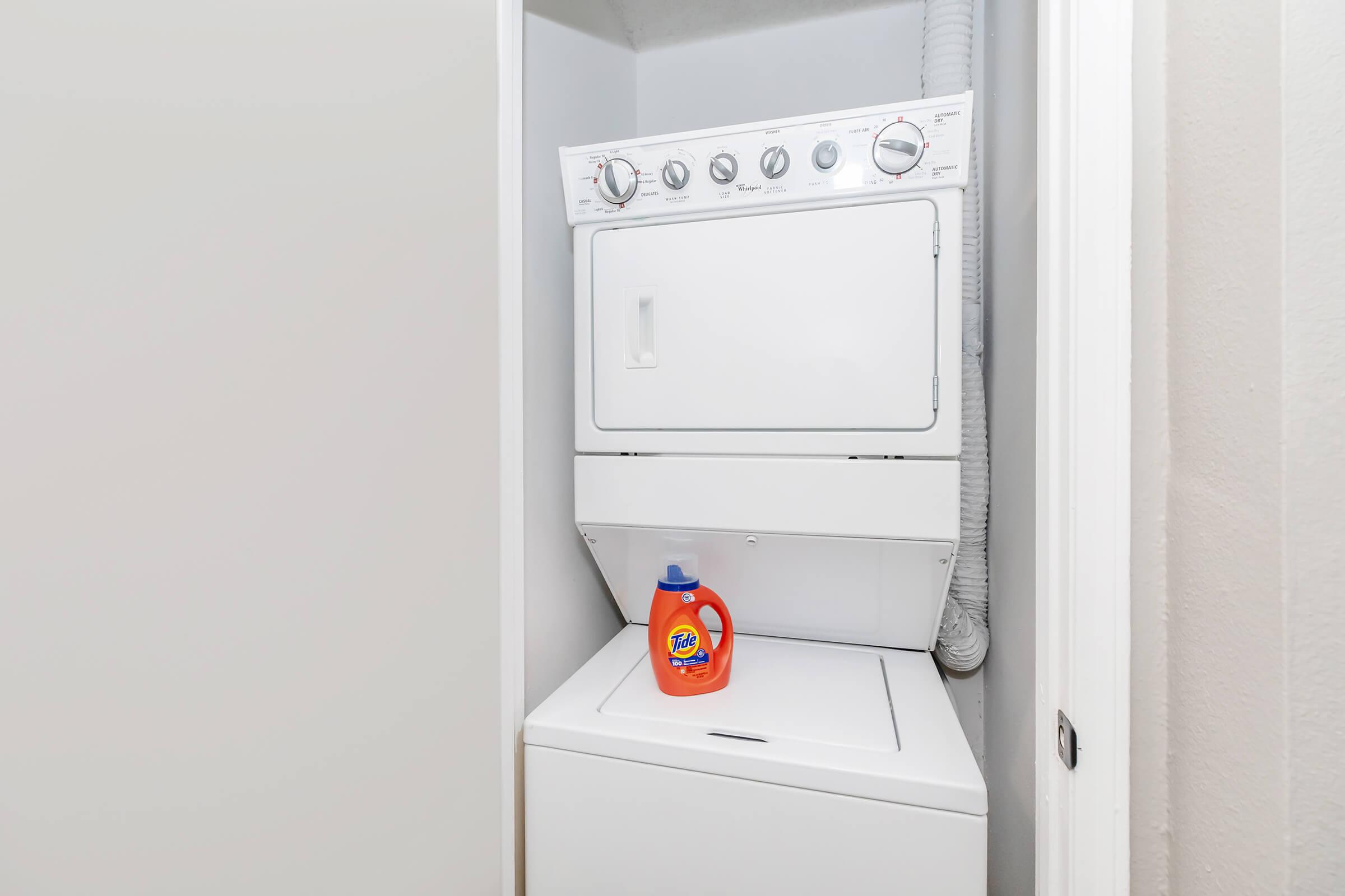 a cat sitting on top of a refrigerator