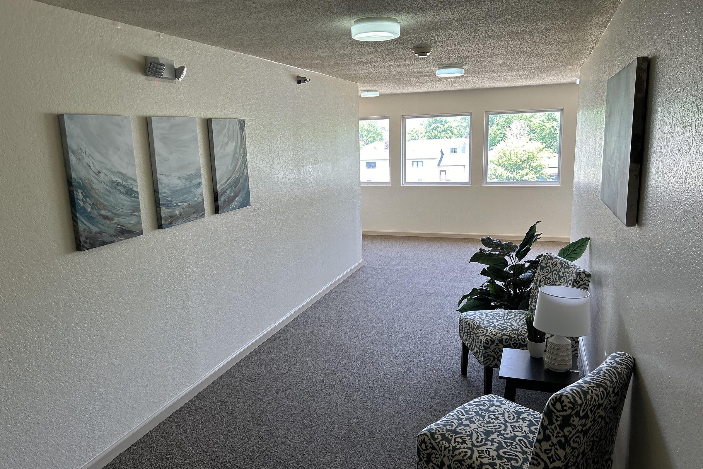 a room filled with furniture and a large window