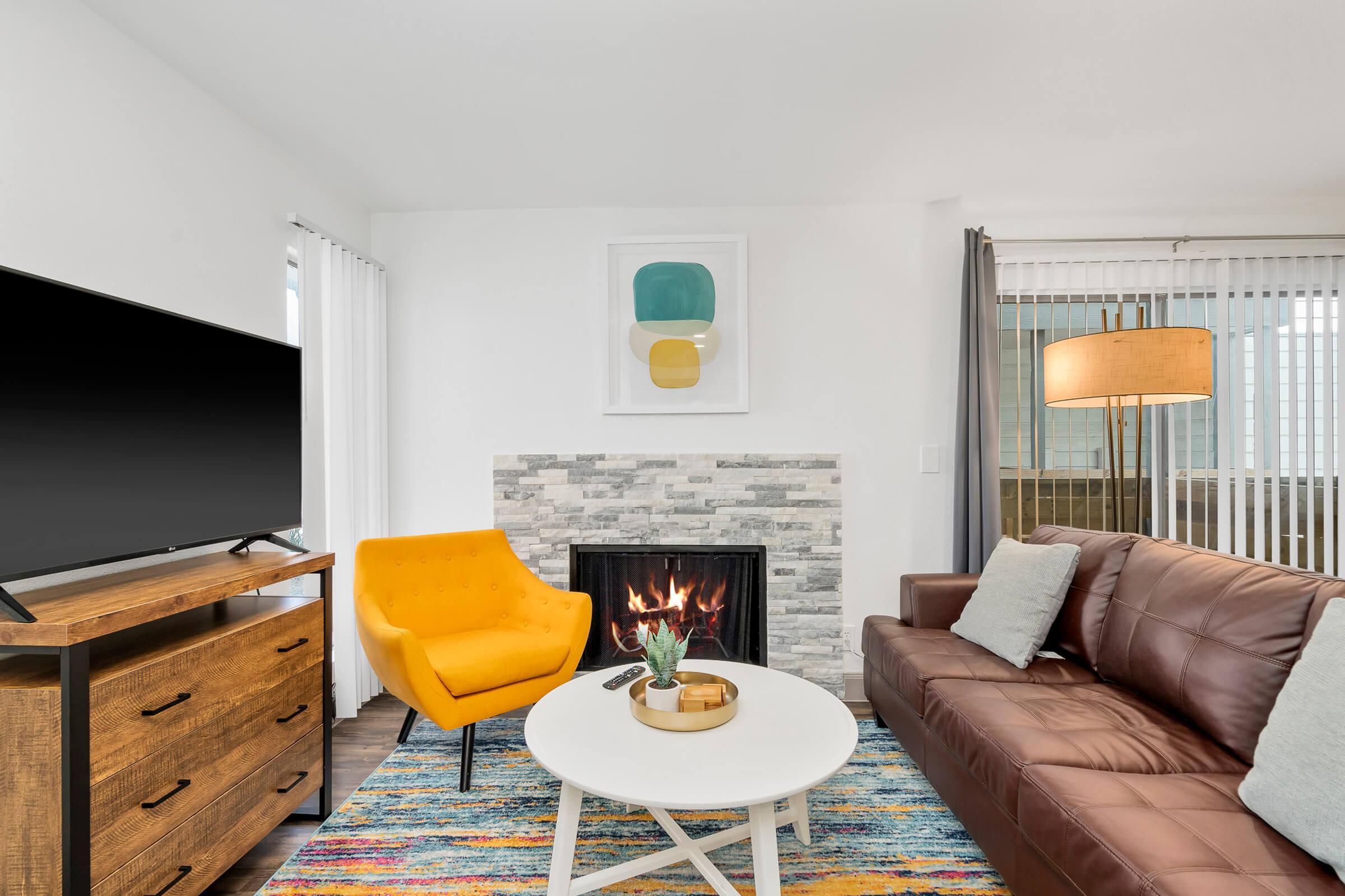 a living room filled with furniture and a flat screen tv