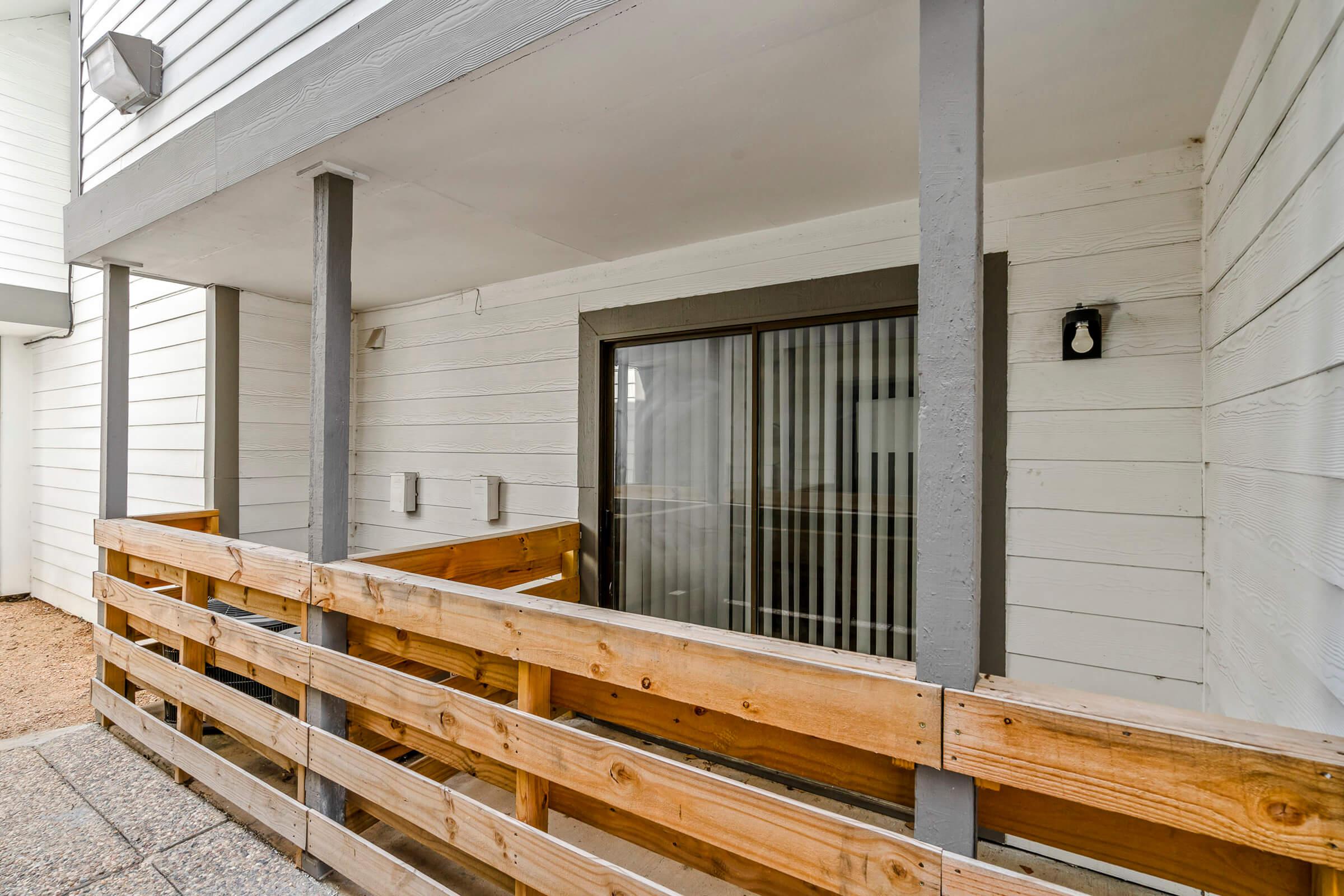 a wooden bench in front of a building