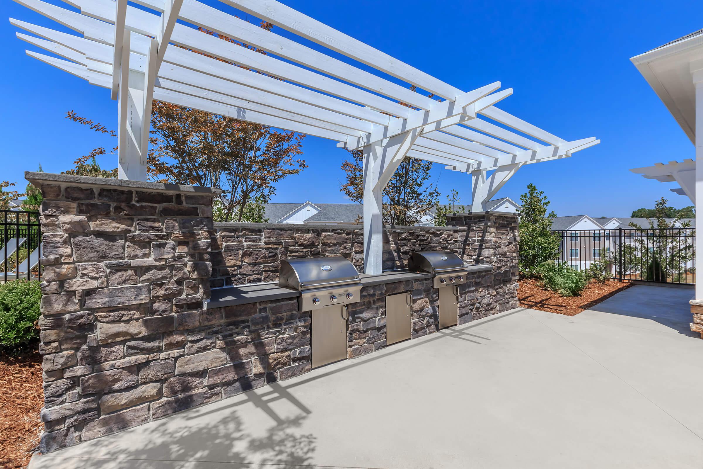 Enjoy A Barbecue with Friends At Riverstone Apartments At Long Shoals In Arden, NC 