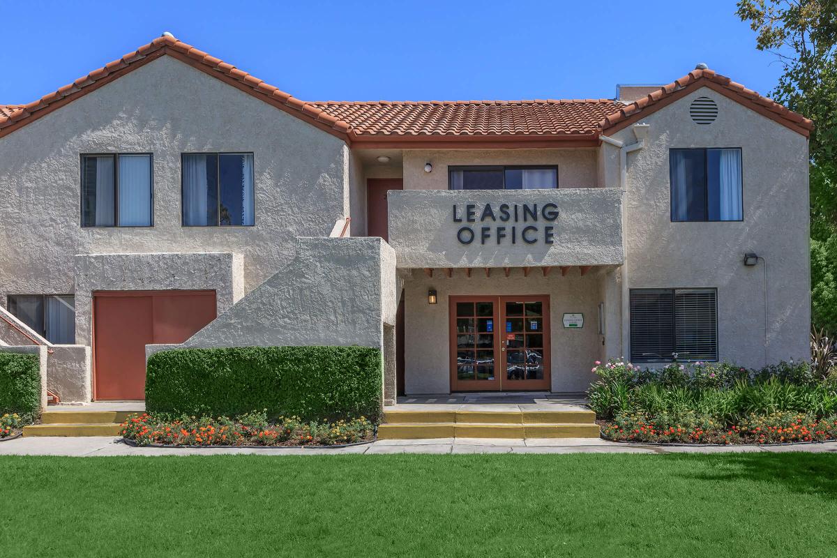 a house with a lawn in front of a building