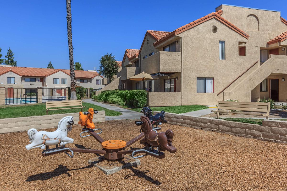 a group of people sitting around a fire hydrant in front of a house