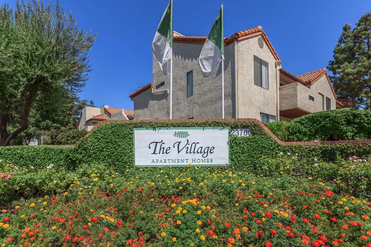 a large brick building with a sign in front of a house