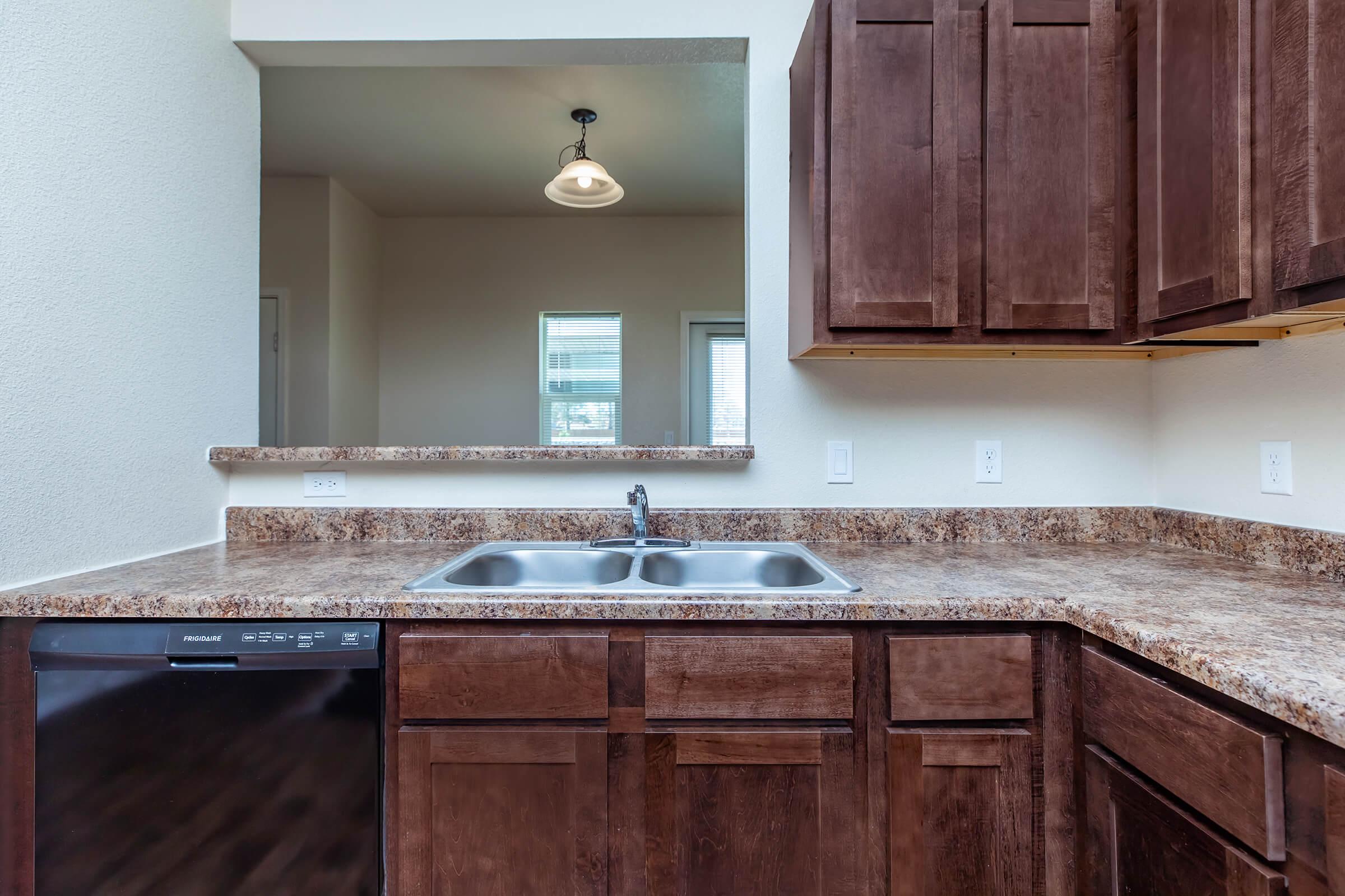 a kitchen with a sink and a window