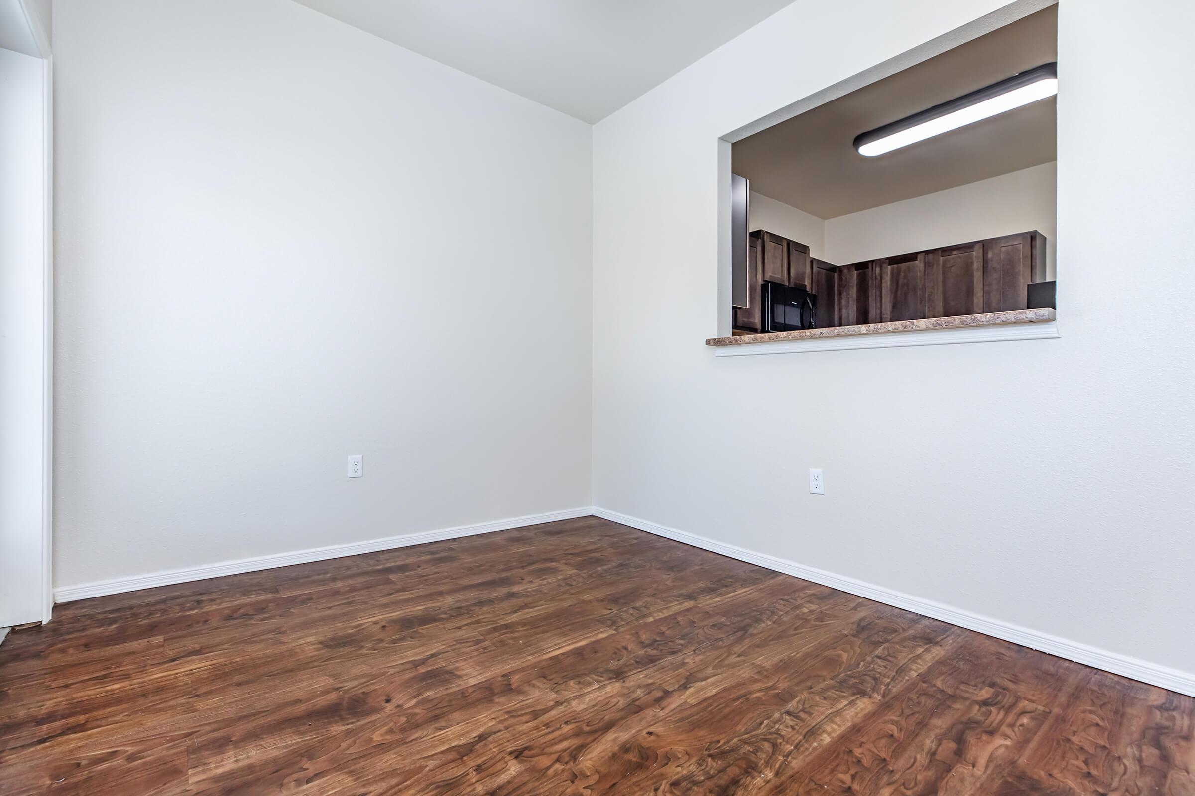 a bedroom with a wooden floor