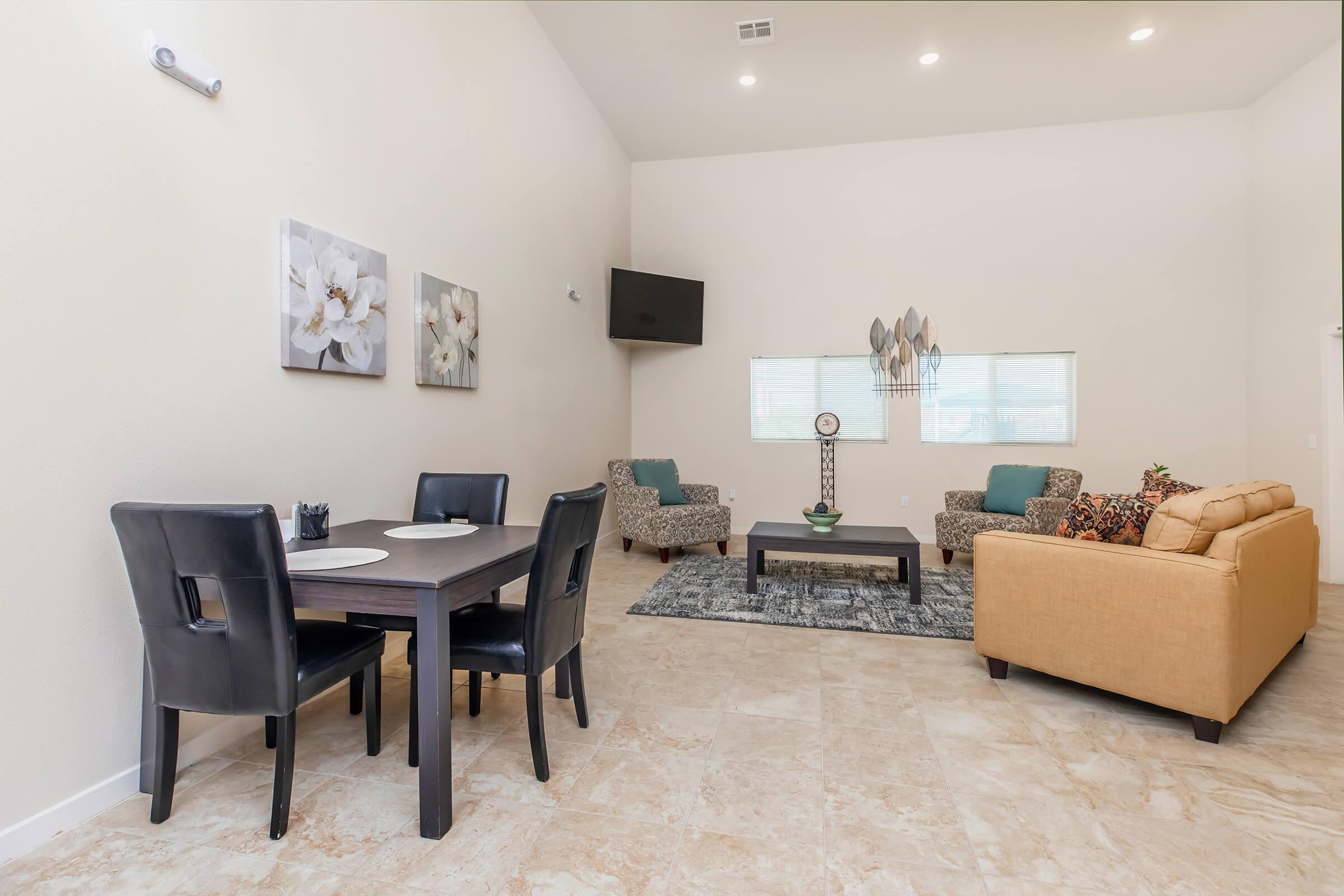 a living room filled with furniture and a table