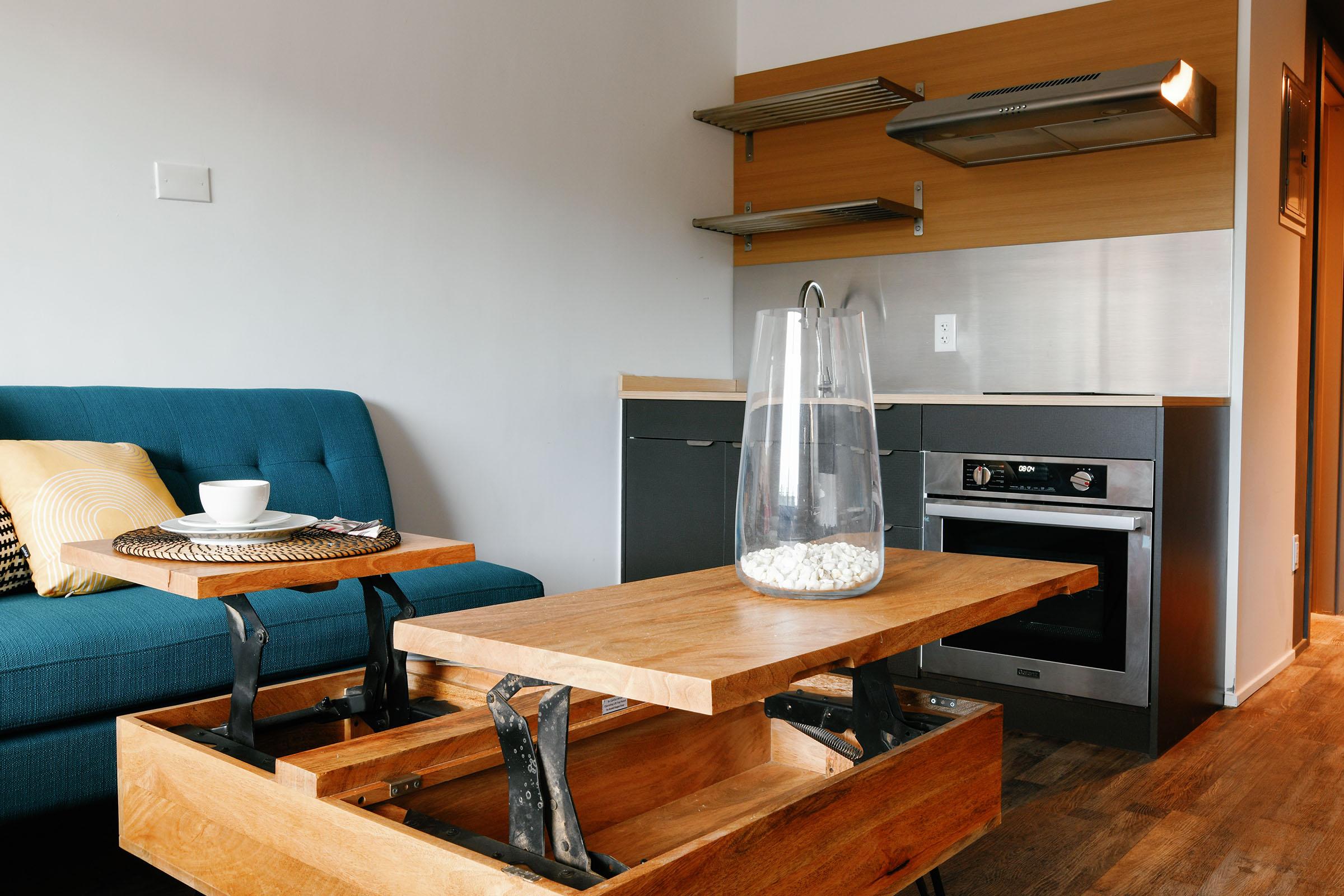 a kitchen with a stove top oven sitting inside of a wooden table