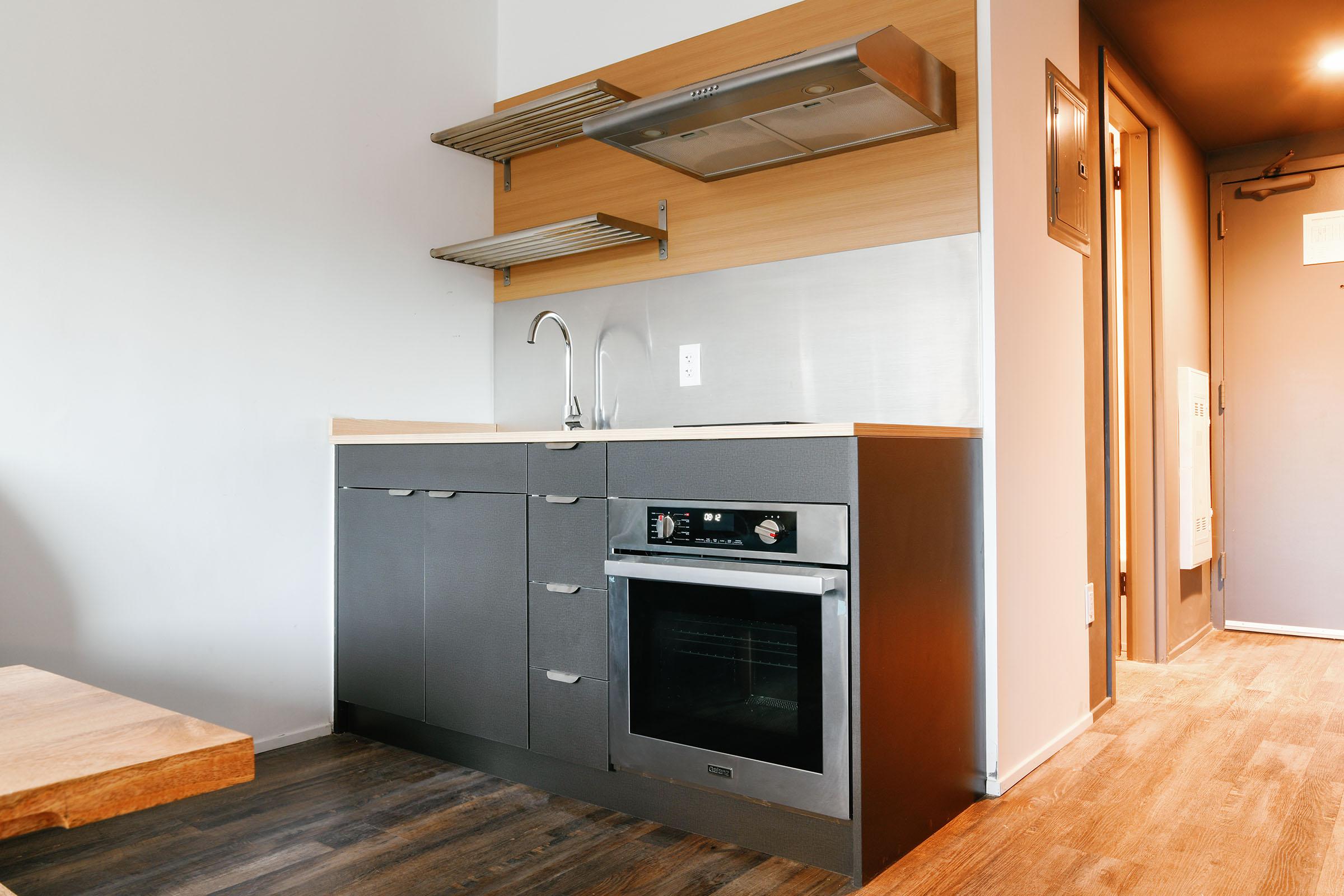 a kitchen with a stove top oven sitting inside of a building