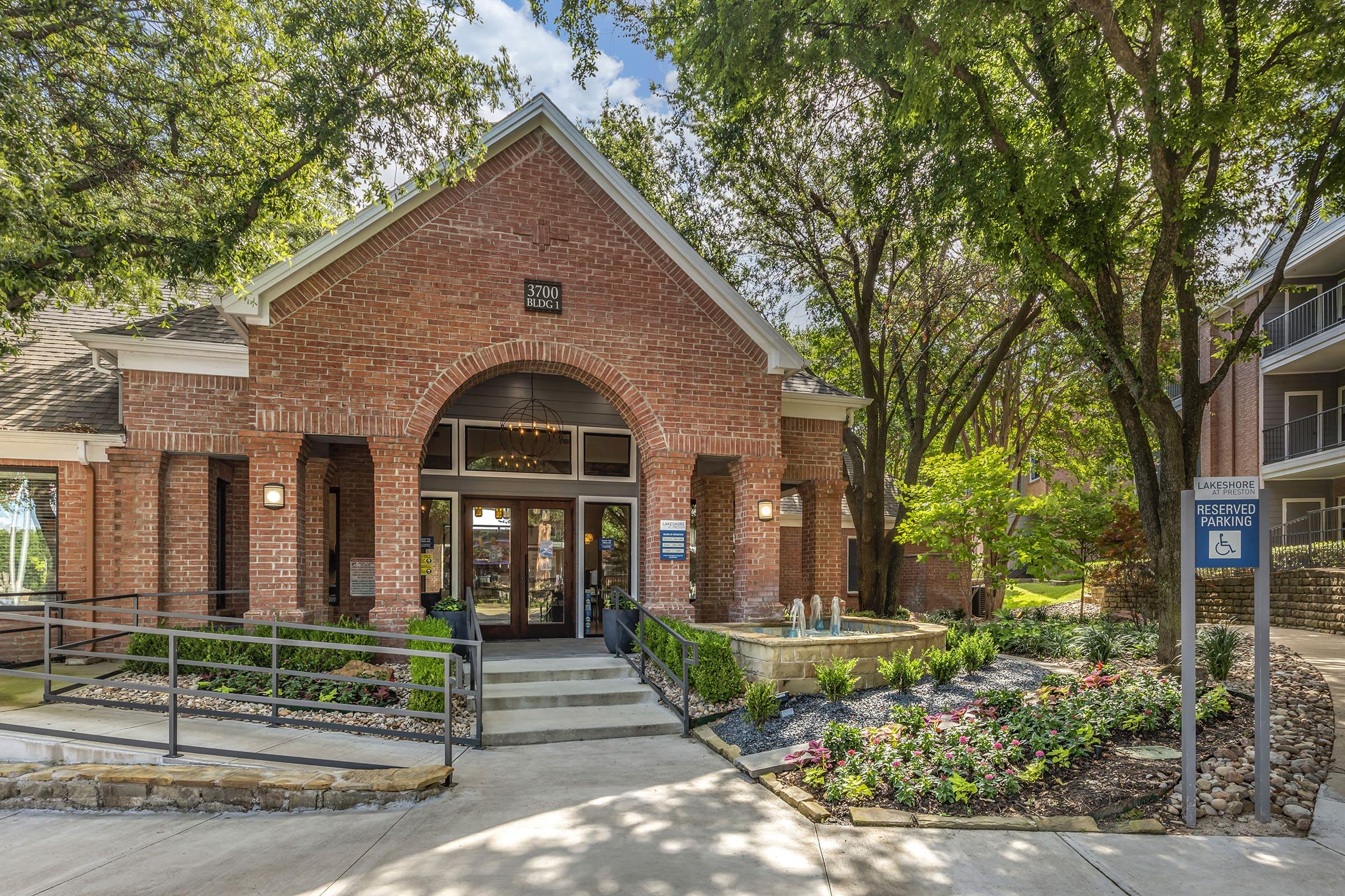 a garden in front of a brick building