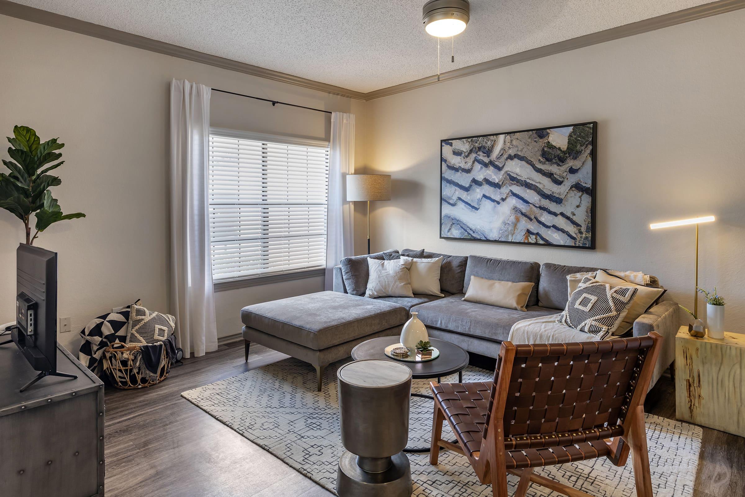 a living room filled with furniture and a large window