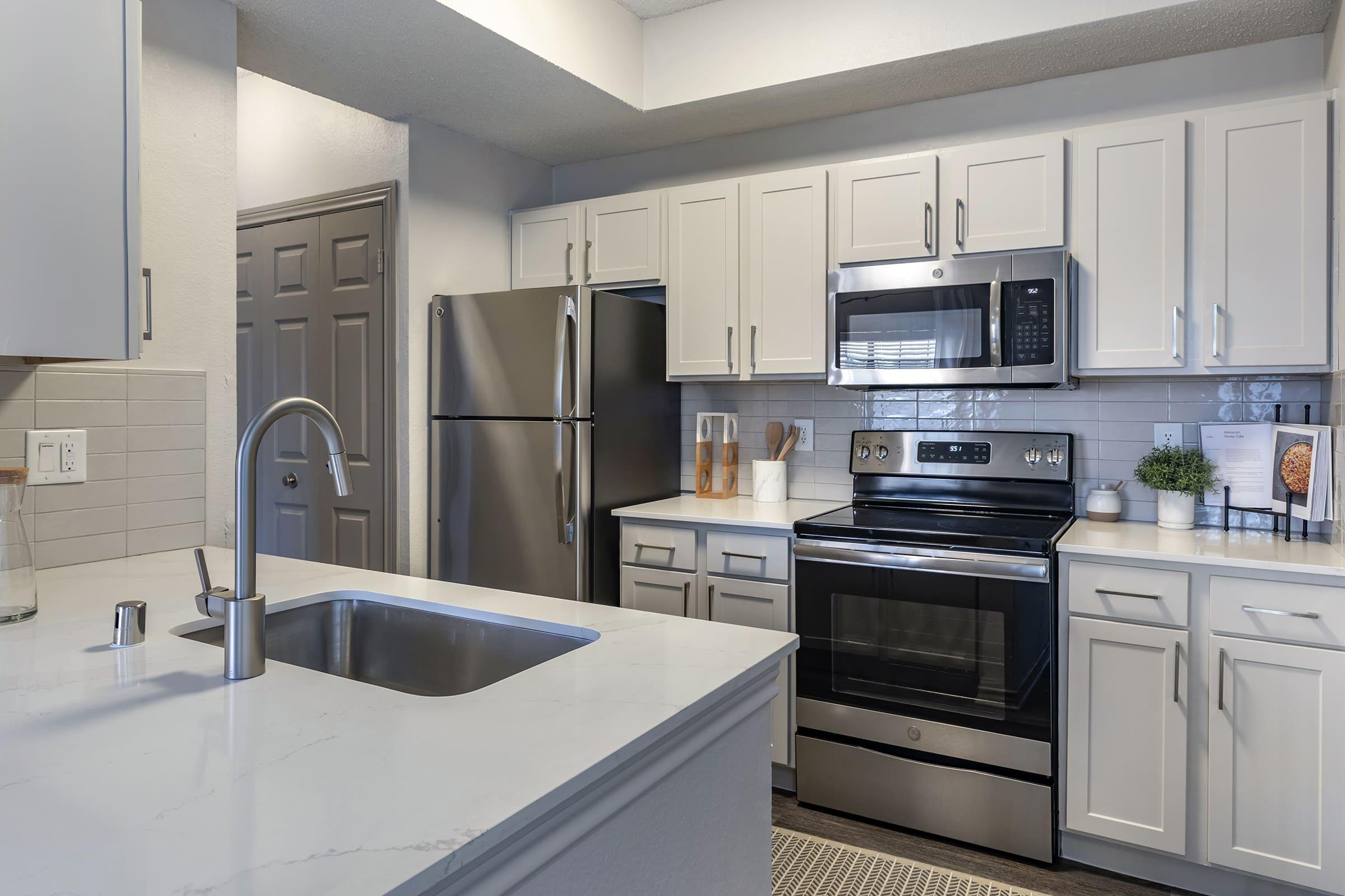 a modern kitchen with stainless steel appliances