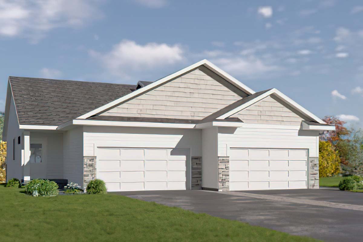 A modern residential duplex featuring two connected units with white siding, a gray shingle roof, and stone accents. The front has two large garages and a well-maintained lawn with decorative shrubs. The background includes a blue sky with scattered clouds, emphasizing a pleasant neighborhood setting.