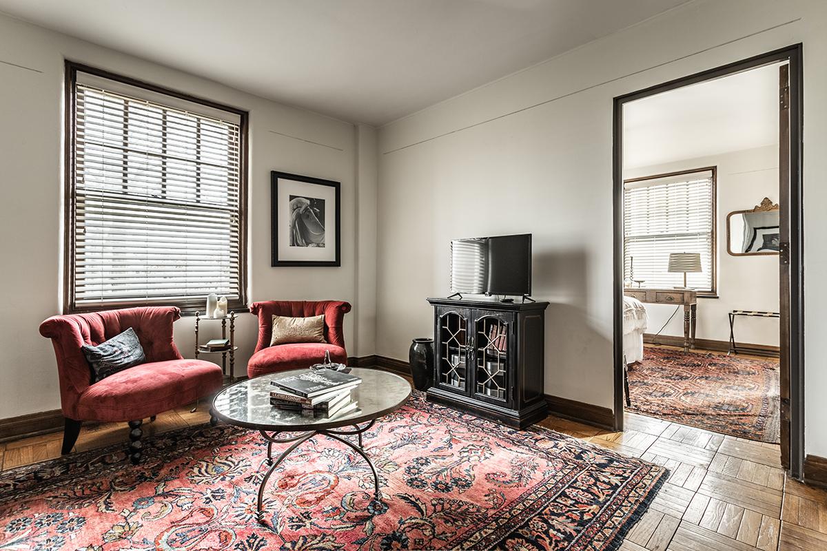 a living room filled with furniture and a flat screen tv