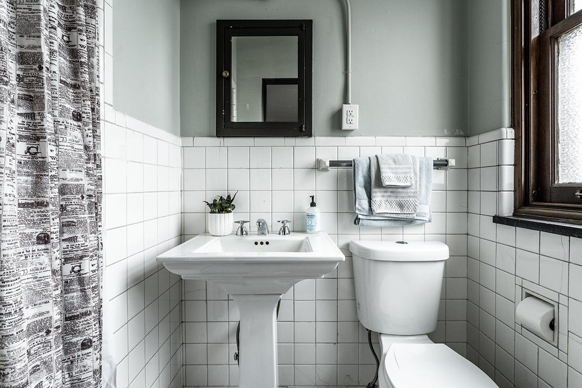 a restroom with a sink and a window