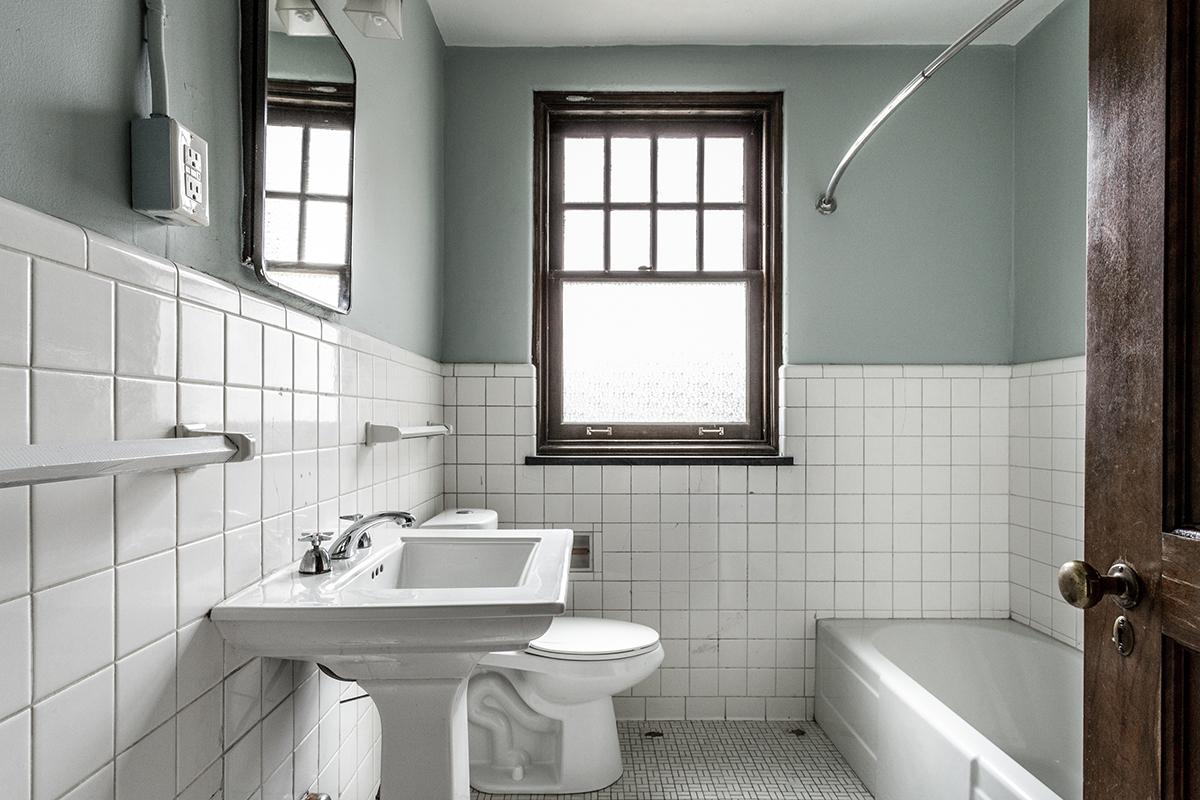 a restroom with a sink and a window