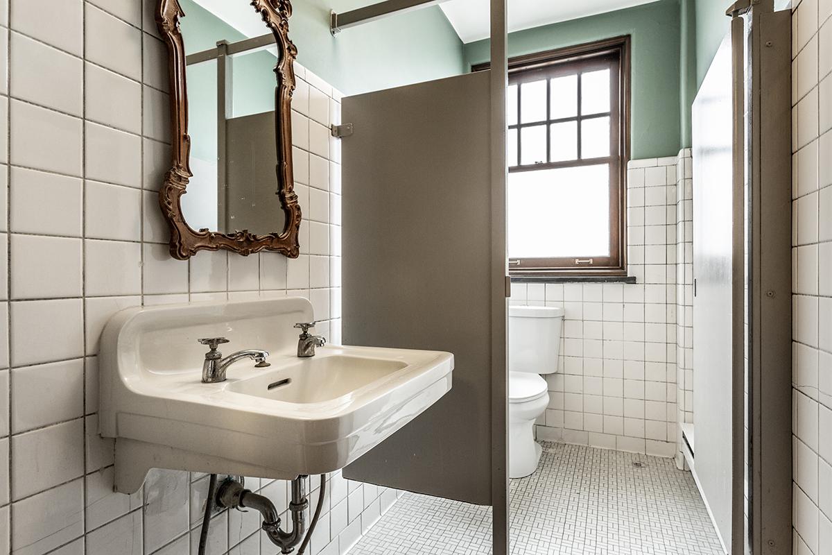 a room with a sink and a mirror