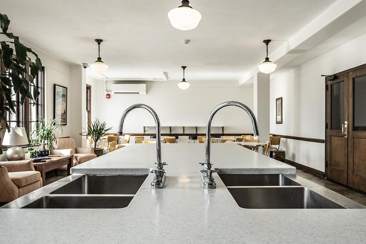a kitchen with a sink and a mirror