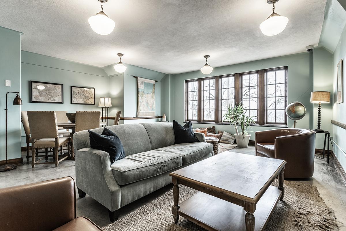 a living room filled with furniture and a large window