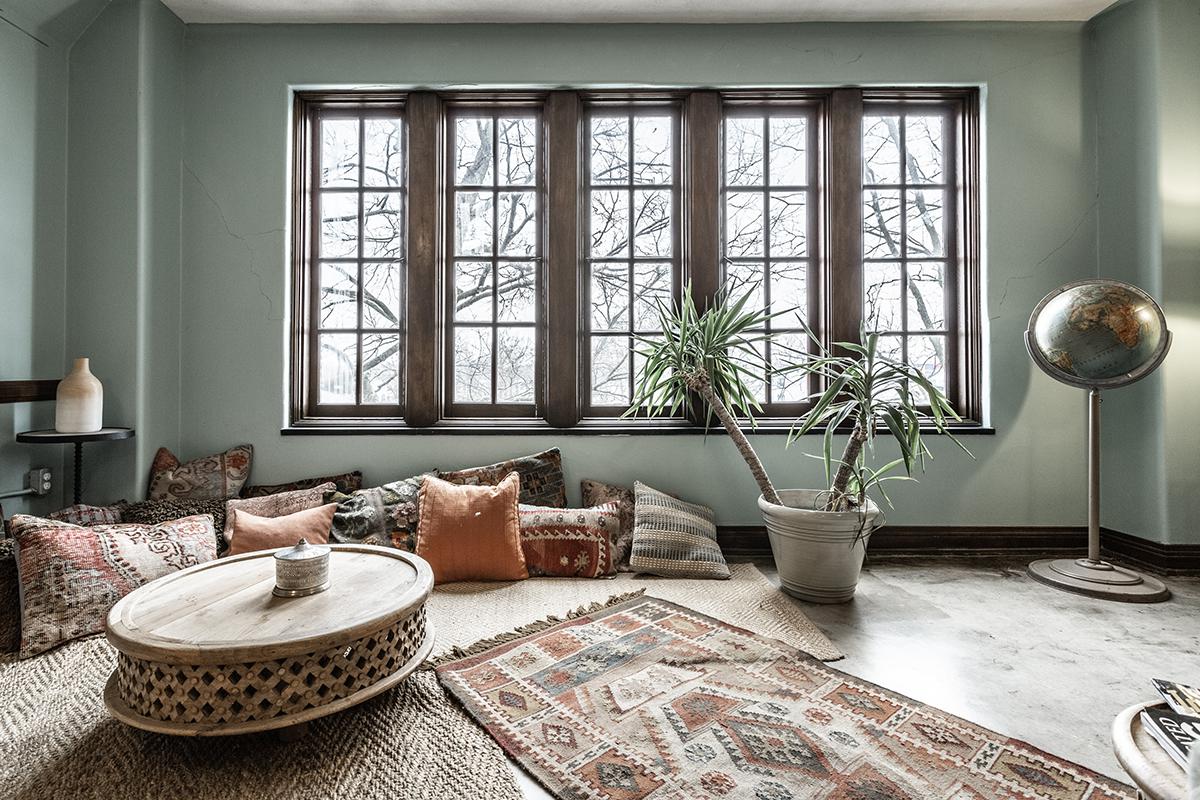 a living room filled with furniture and a large window