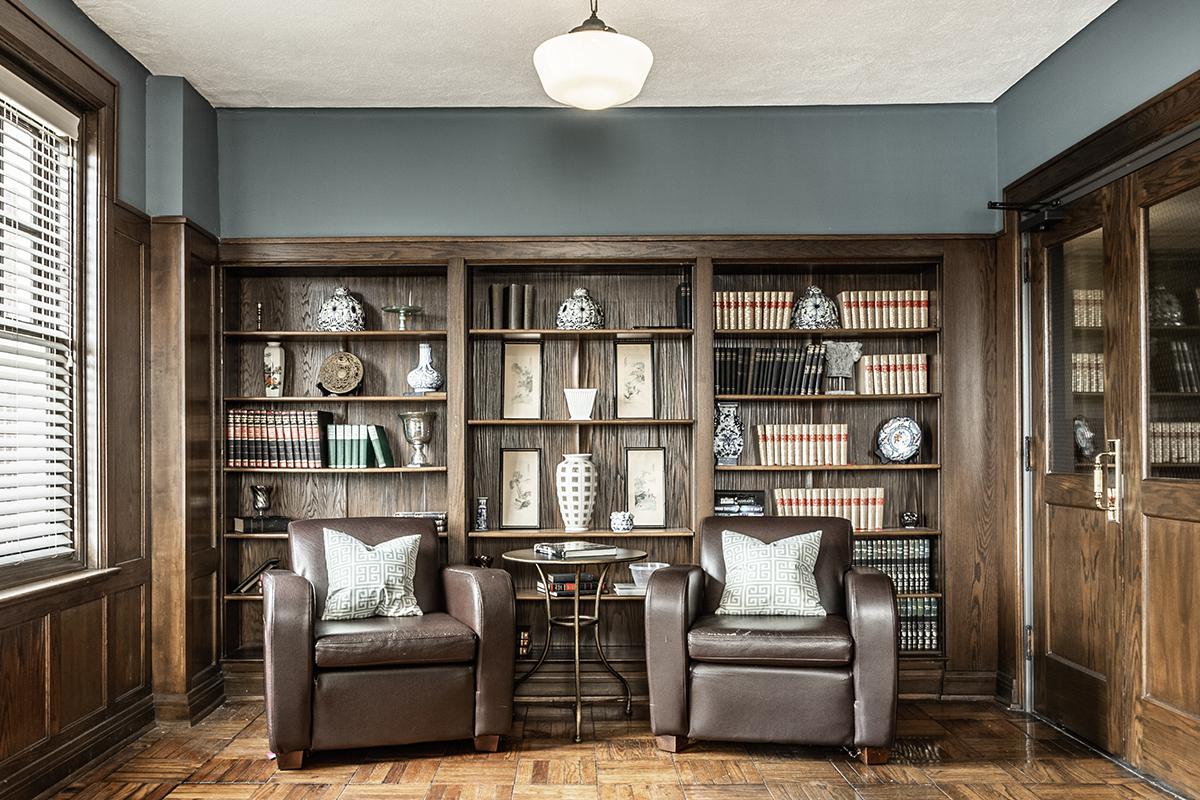 a living room filled with furniture and a large window