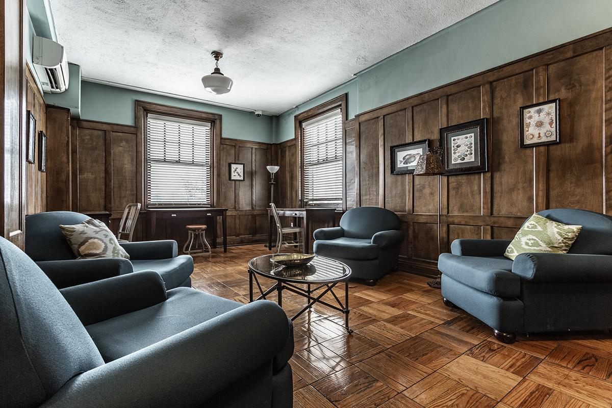 a living room filled with furniture and a large window