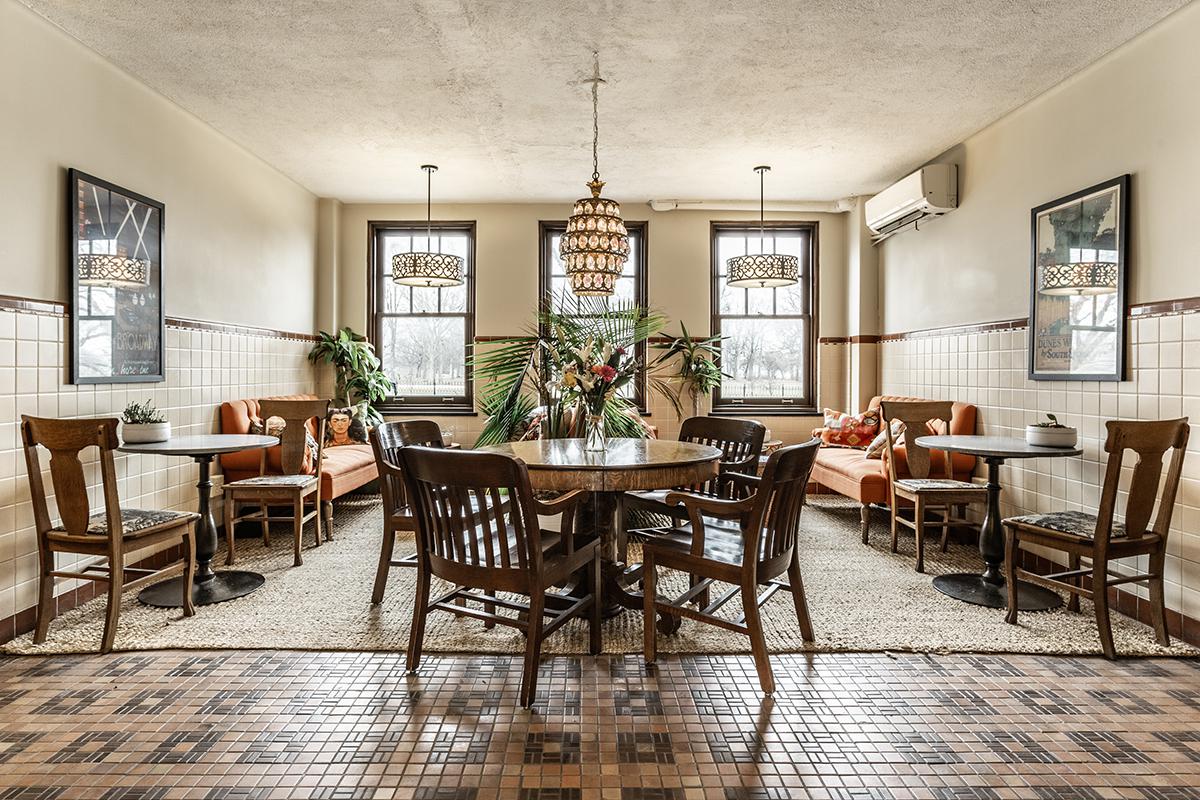a living room filled with furniture and a dining table