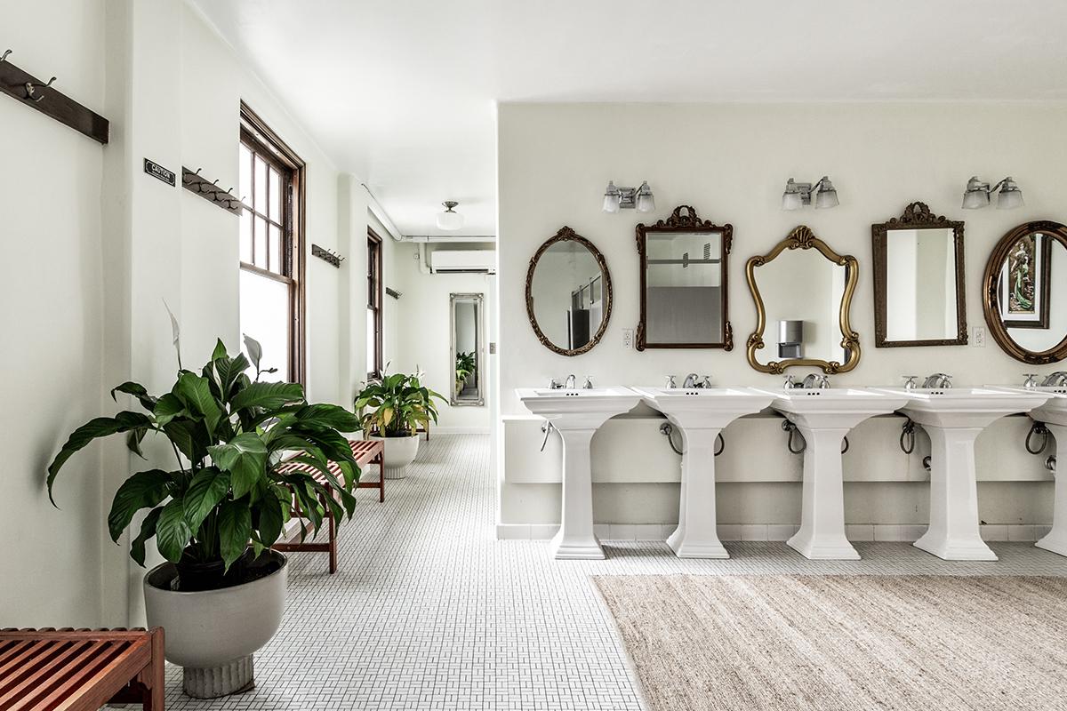 a room filled with furniture and vase of flowers on a table