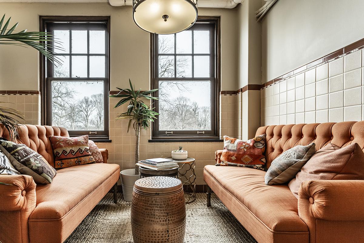 a living room filled with furniture and a large window