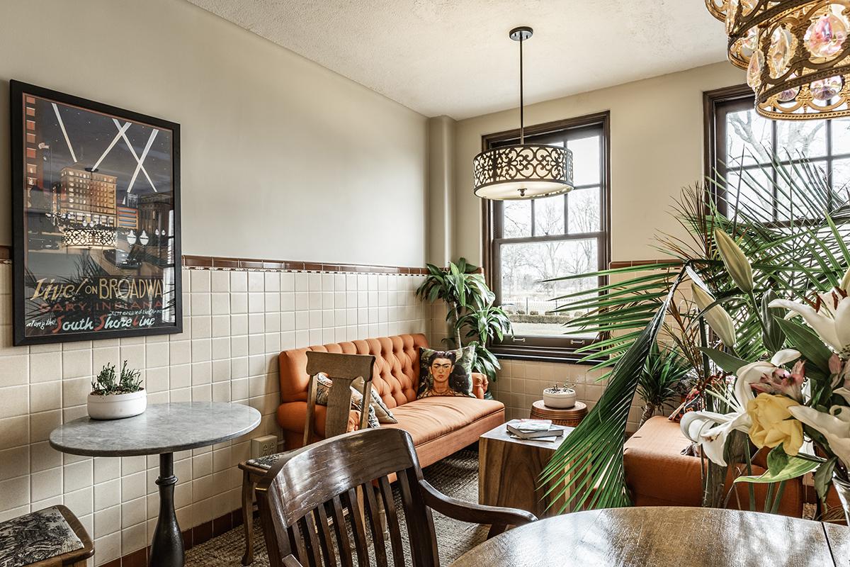 a living room filled with furniture and vase of flowers on a table