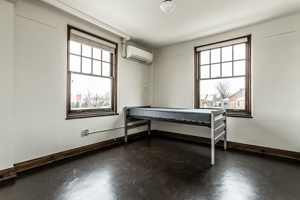 a living room filled with furniture and a large window