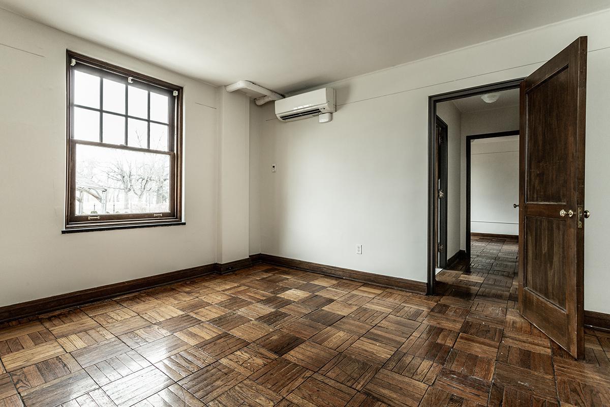 a room with a tiled floor next to a window