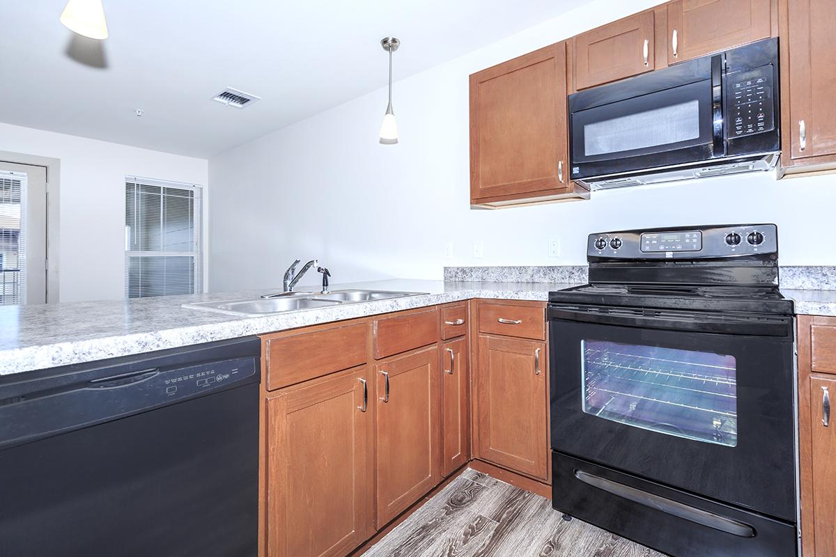 a kitchen with stainless steel appliances and wooden cabinets