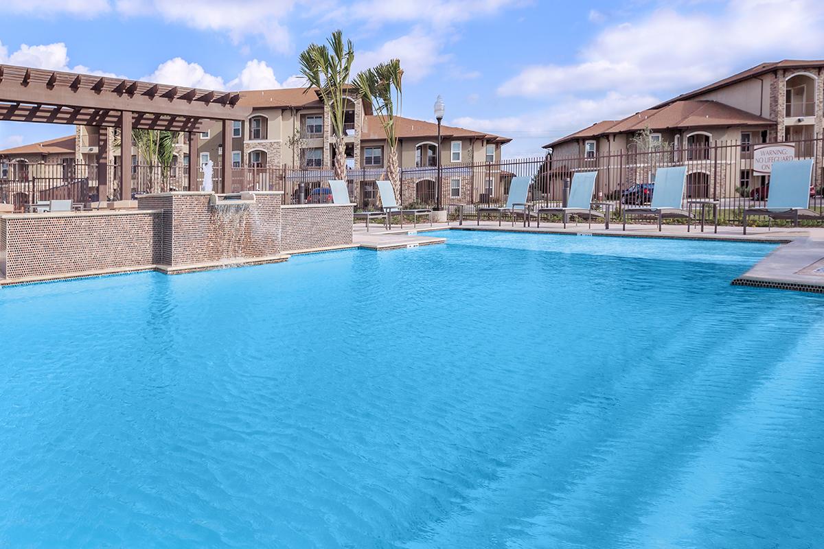 a large pool of water in front of a house