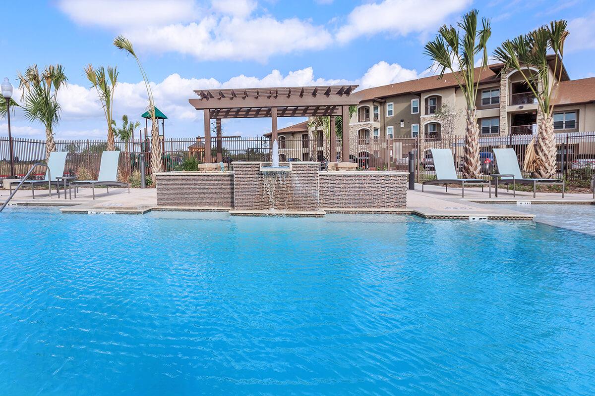 a large pool of water in front of a house