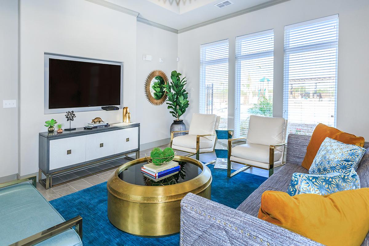 a living room filled with furniture and a large window