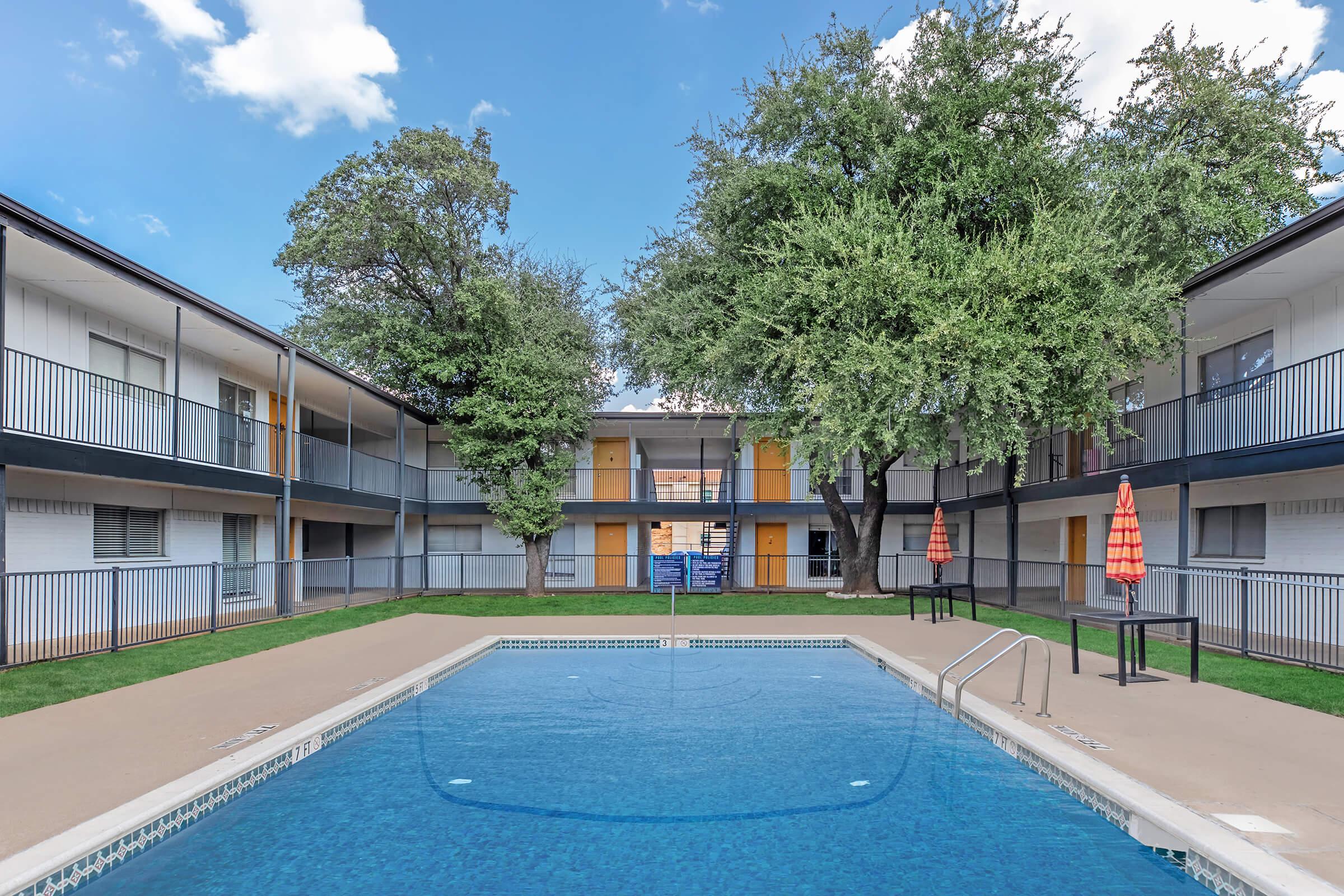 a house with a pool in front of a building