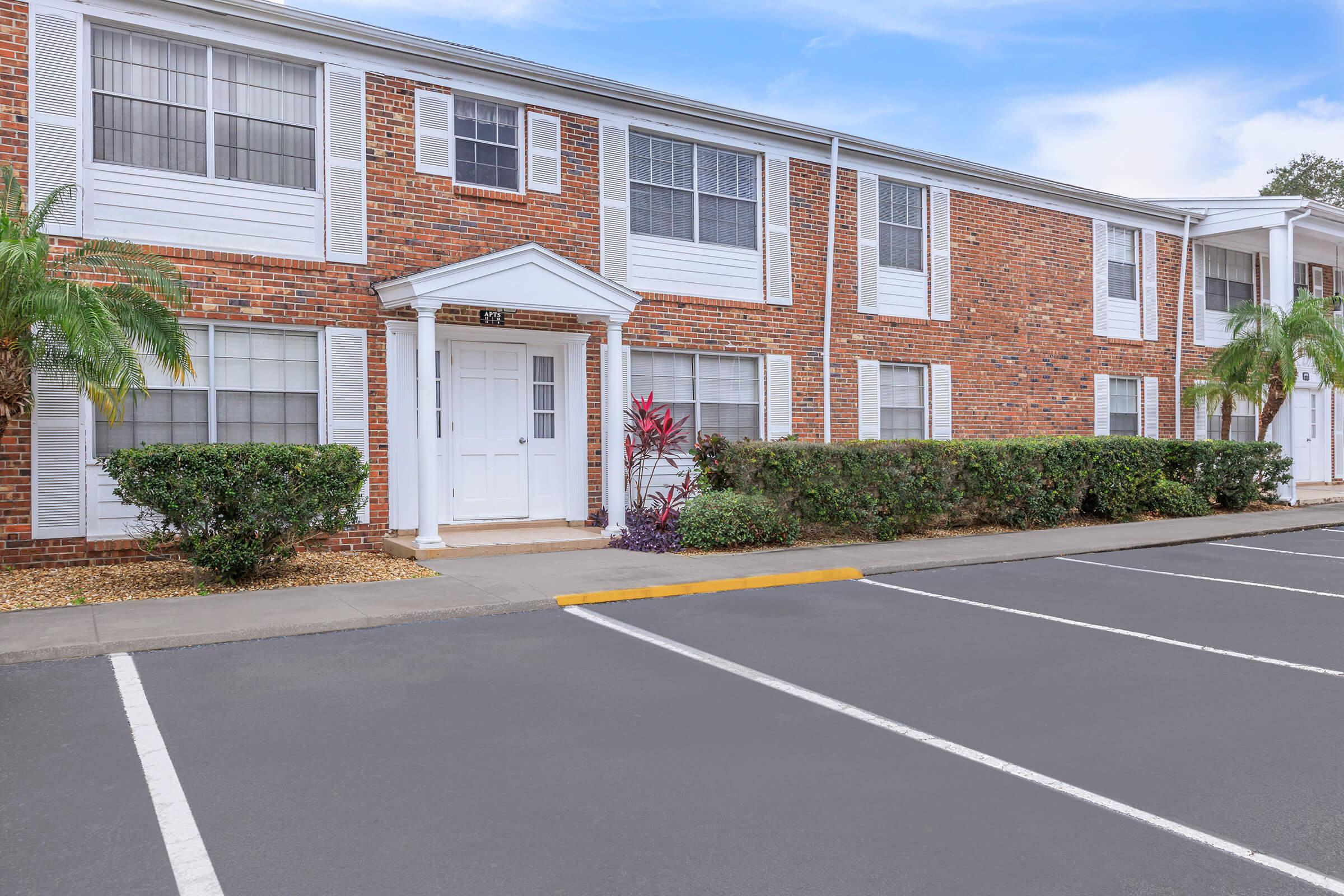 an empty road in front of a brick building