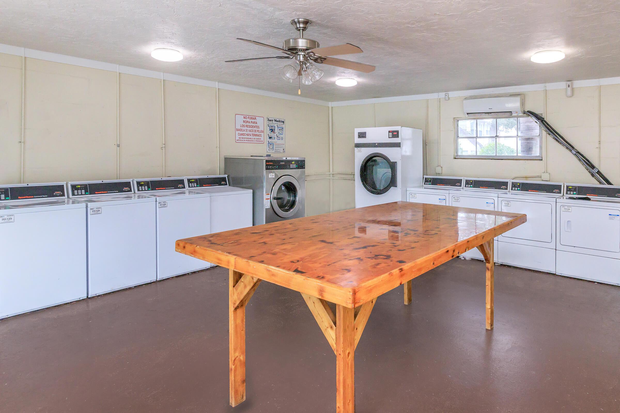 a kitchen with a stove top oven sitting inside of a wooden table