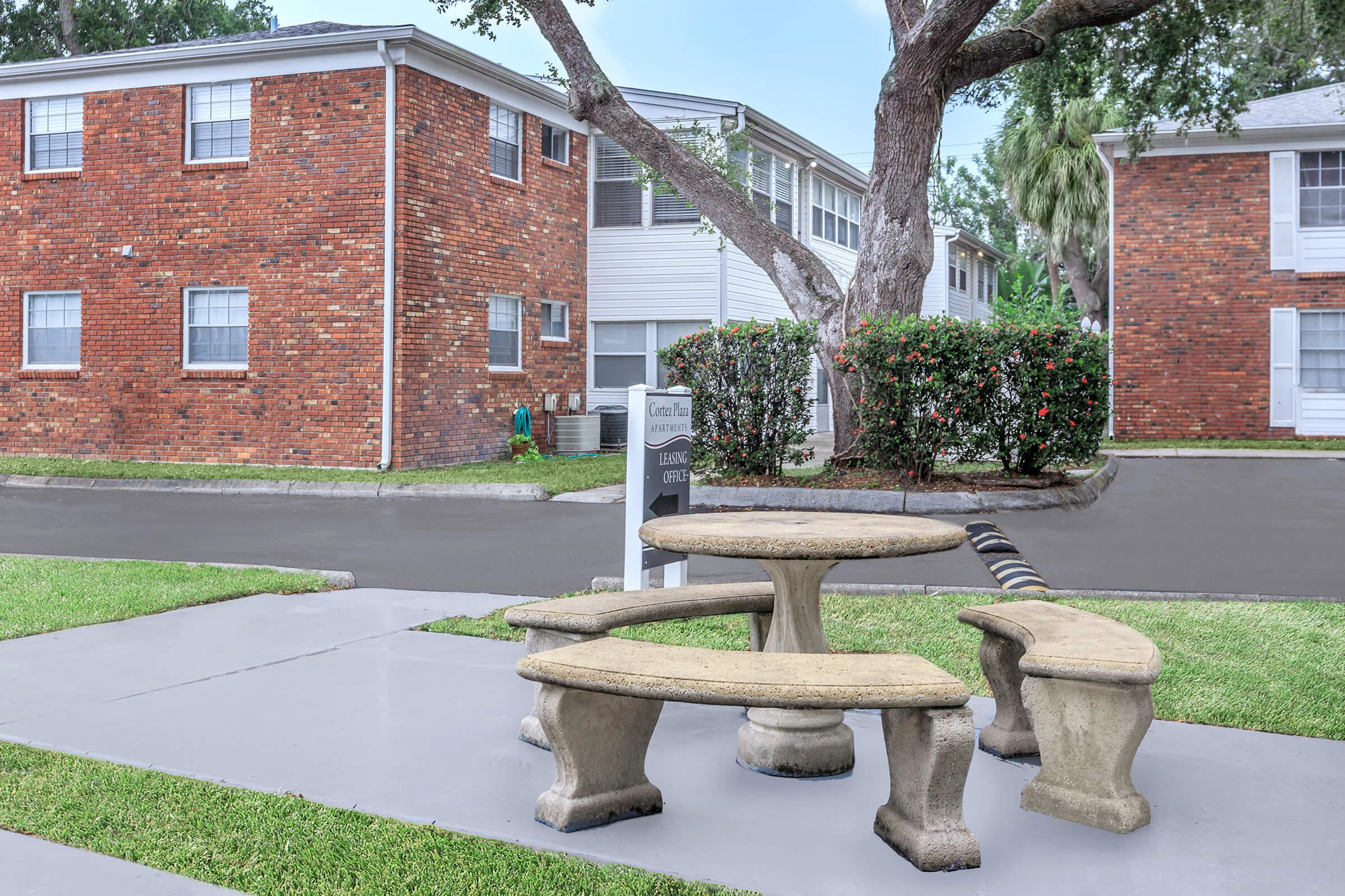 a bench in front of a brick building