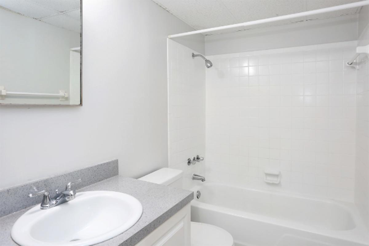 a white tub sitting next to a sink