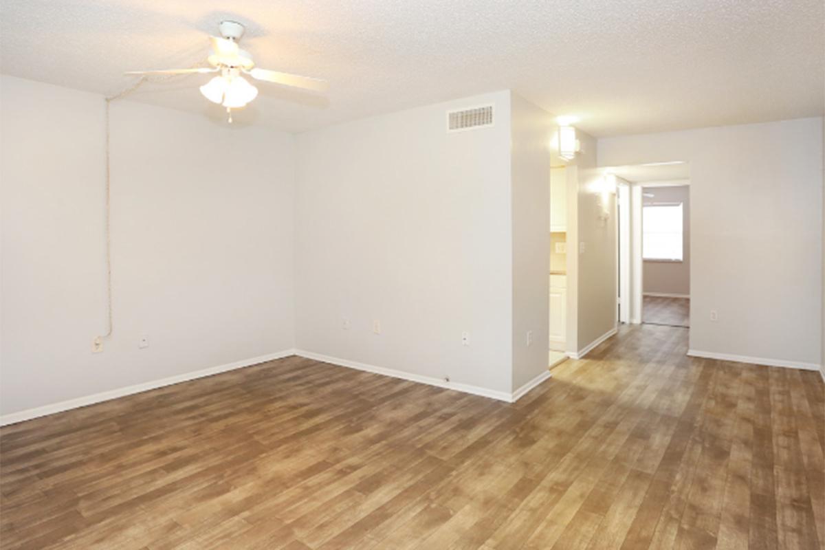 a large empty room with a wood floor