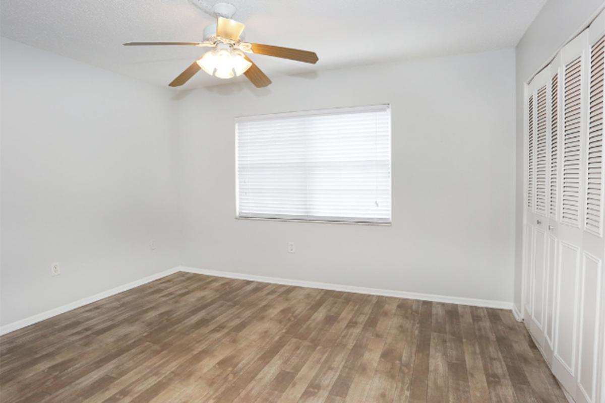 a room with white walls and a large window