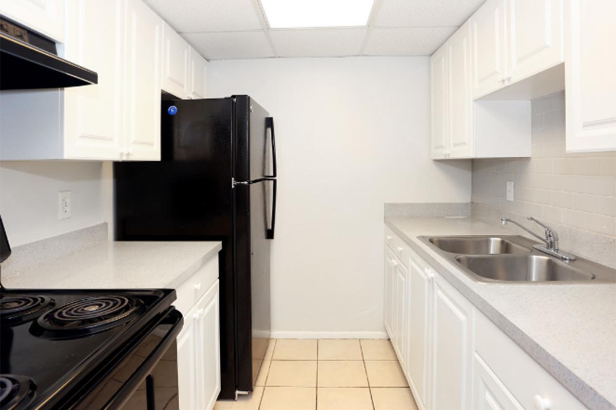 a stove top oven sitting inside of a kitchen with stainless steel appliances