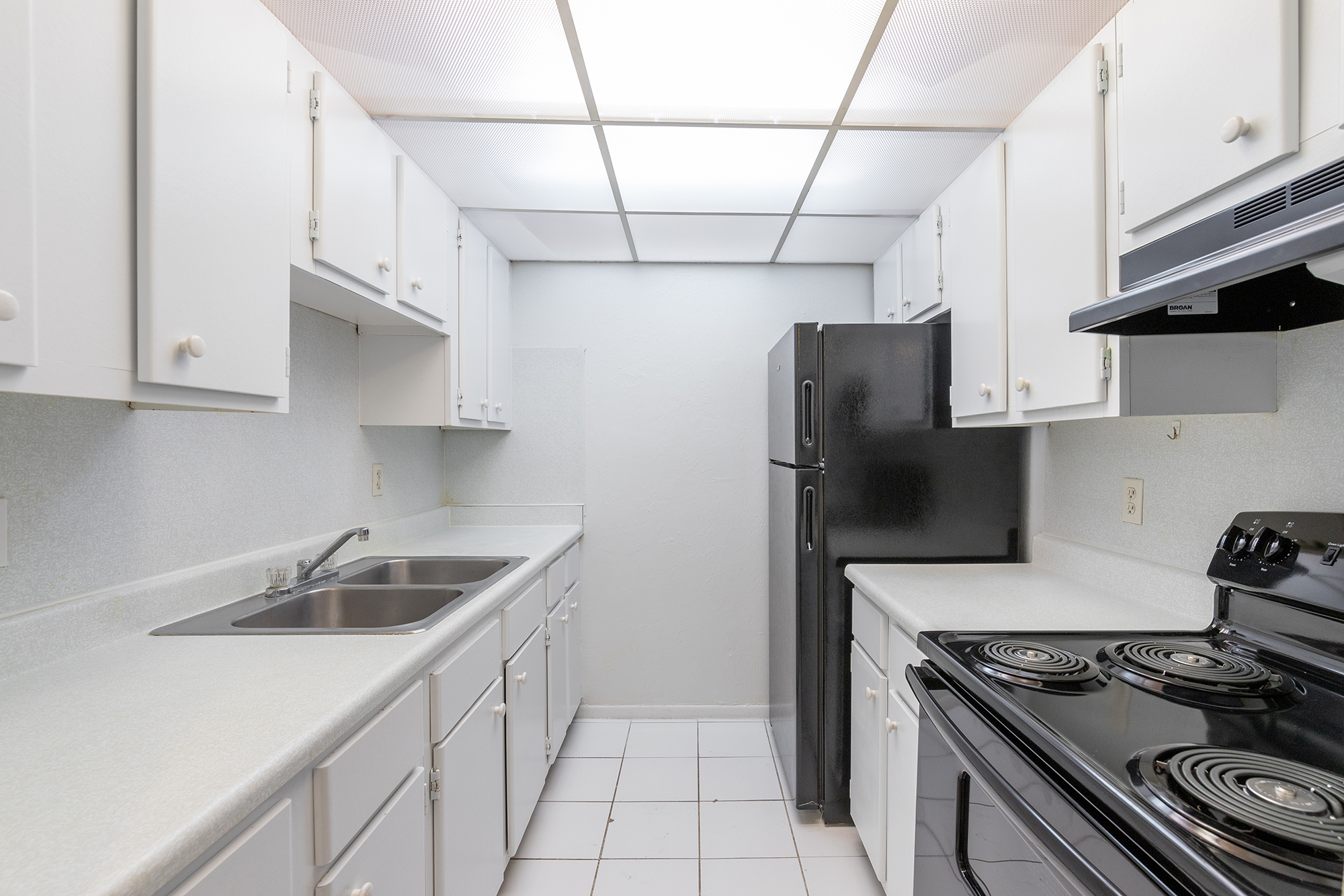 a stove top oven sitting inside of a kitchen