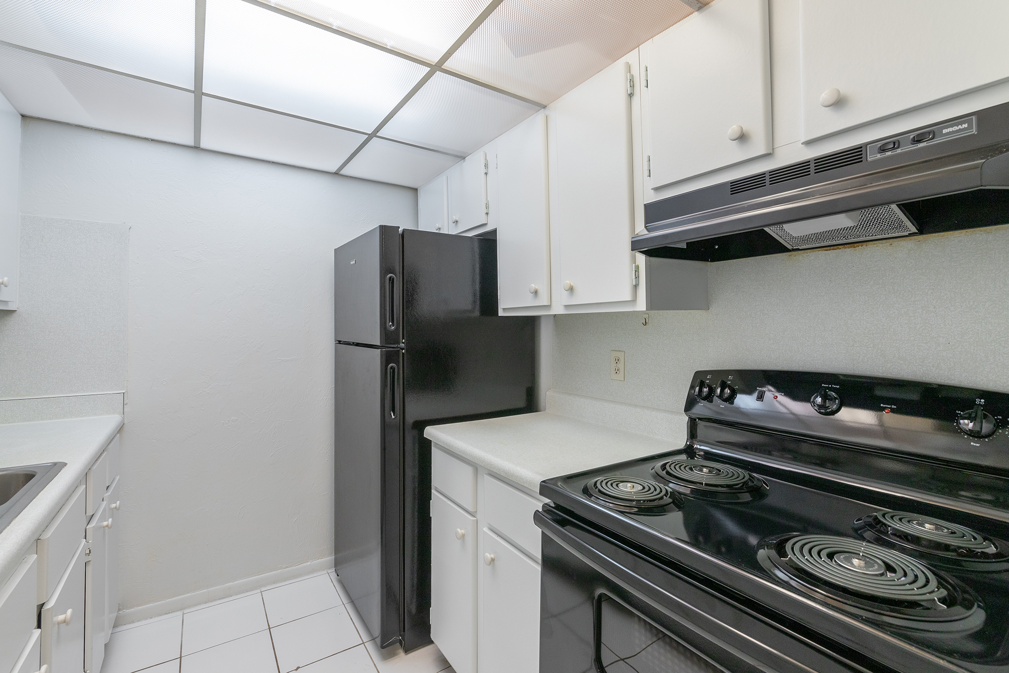 a stove top oven sitting inside of a kitchen